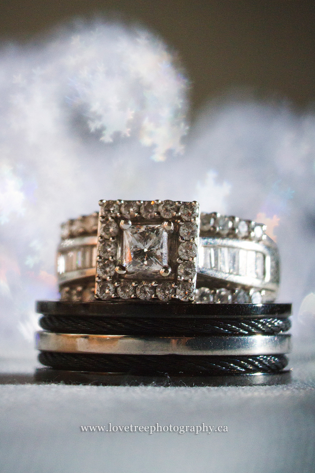 snow bokeh with wedding rings, using filters at winter weddings; image by www.lovetreephotography.ca