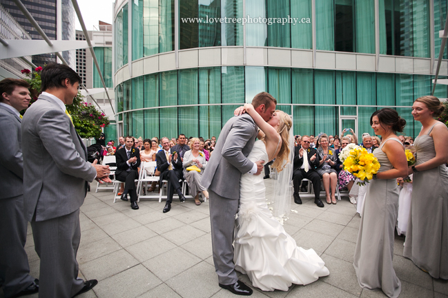 wedding kiss at the marriott pinnacle hotel in downtown vancouver ; image by award winning Canadian wedding photographers www.lovetreephotography.ca